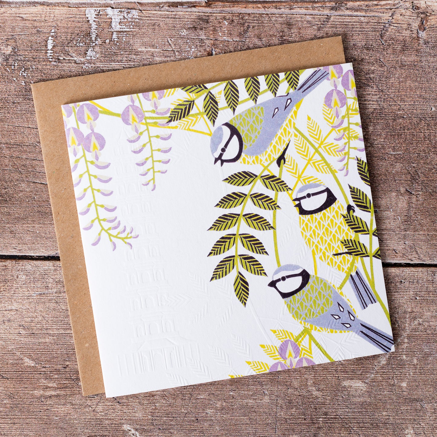 This high quality, linocut printed, Blue Tit card has been handcrafted by the talented Ashley Hutchinson in his rural West Sussex garden studio. This design features three colourful Blue Tits sitting in a tree on an embossed card background.
