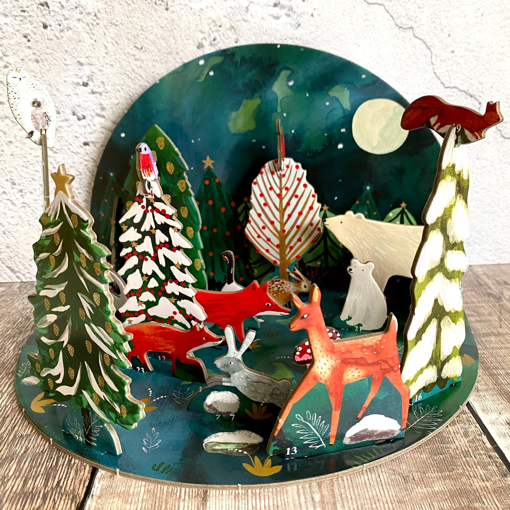 Roger La Borde Northern Lights Pop and Slot 3D Advent Calendar featuring polar bears and forest animals in a winter forest by moonlight.