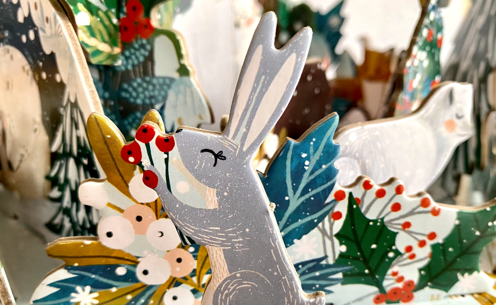 This Polar Bear Bower Advent Calendar design by Antoana Oreski is a beautiful illustration of a nestling polar bears and other winter wildlife.  The snowy bower is constructed at the beginning of Advent and then each day you find, pop out and add the wintry creature or decoration of the day.  By Christmas Eve you will have the most amazing icy landscape scene. 